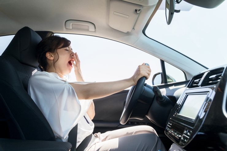 Woman driving a car and throwing something out of the window